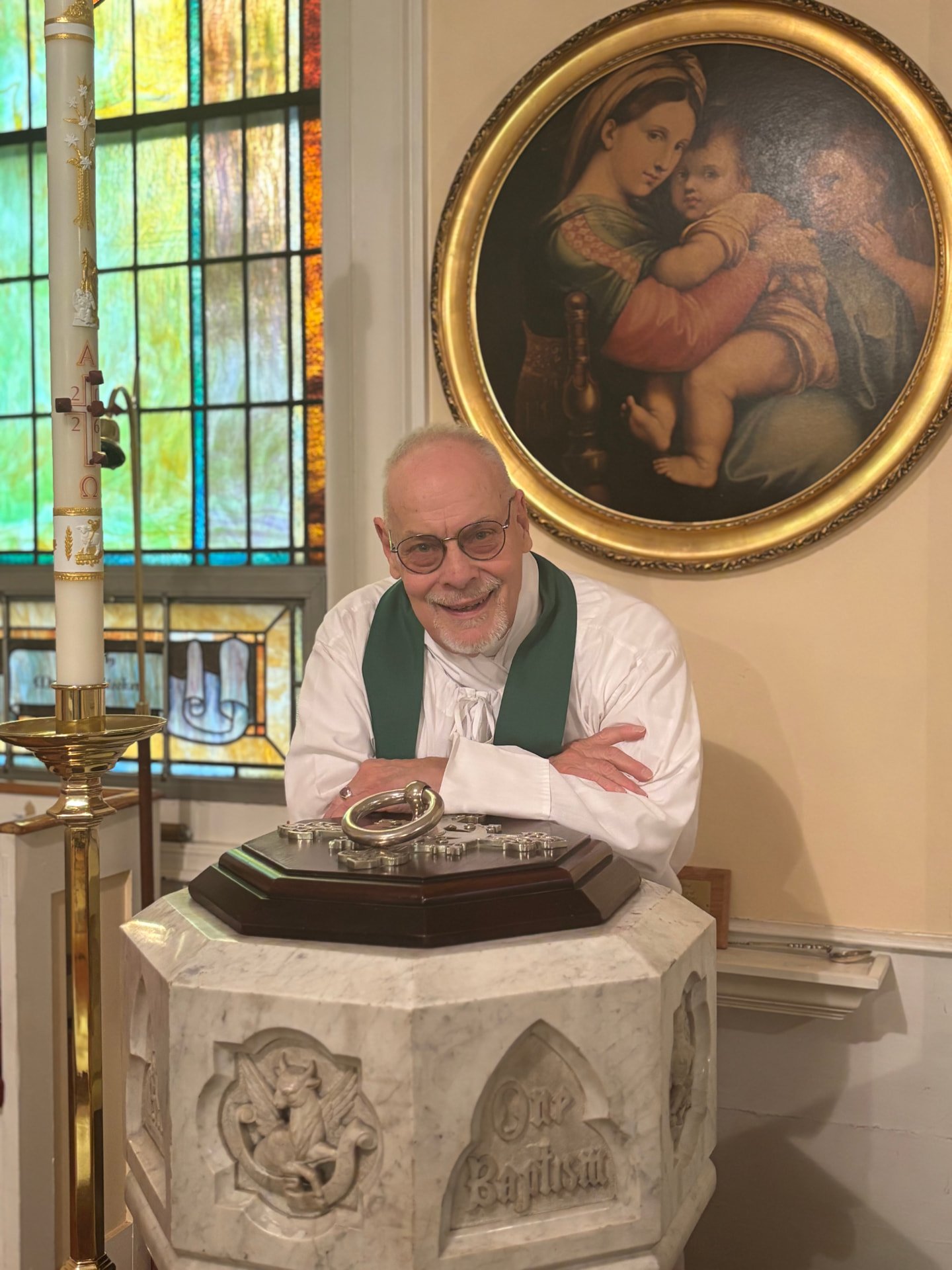 The Rev'd Ronald R. Miller at the baptismal font